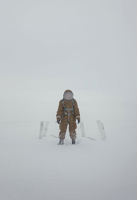 Conceptual portrait of a person in an astronaut suit in a winter scene by fine art photographer Inna Mosina