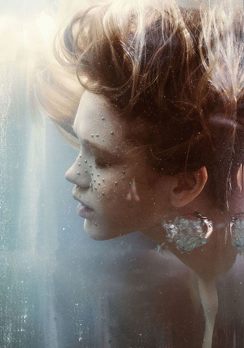 Dreamy underwater portrait of a female model with her eyes closed by fine art photographerMarta Syrko