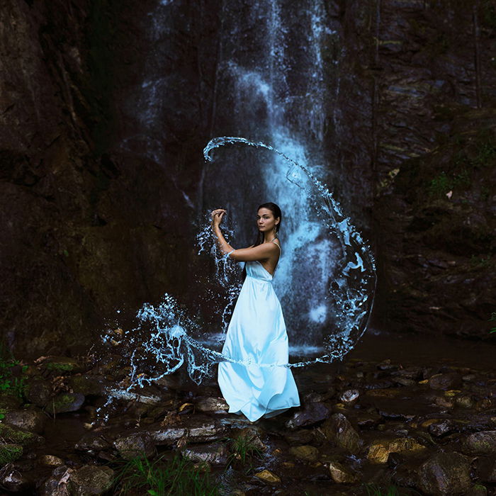 Artistic portrait of a female model posing under a waterfall by fine art photographer Sarah Ann Loreth