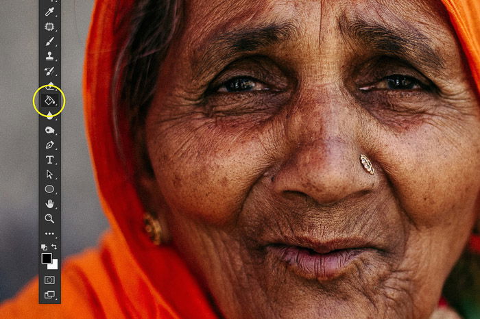 A screenshot showing image sharpening in Photoshop using a portrait of an Indian woman