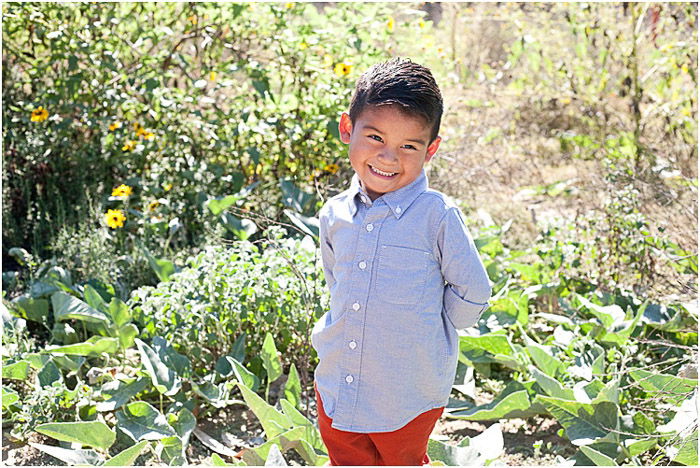 Sweet child photography portrait of a young boy posing outdoors