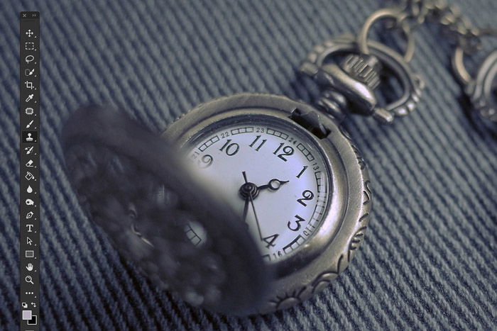 A close up product photography shot of a pocket watch - cleaning the image