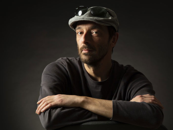 A dark and moody portrait of a male model shot with Rembrandt lighting