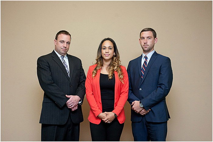 Three people posing for a formal portrait