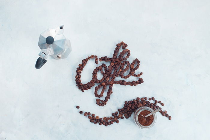 A creative flat lay of food typography and coffee beans 