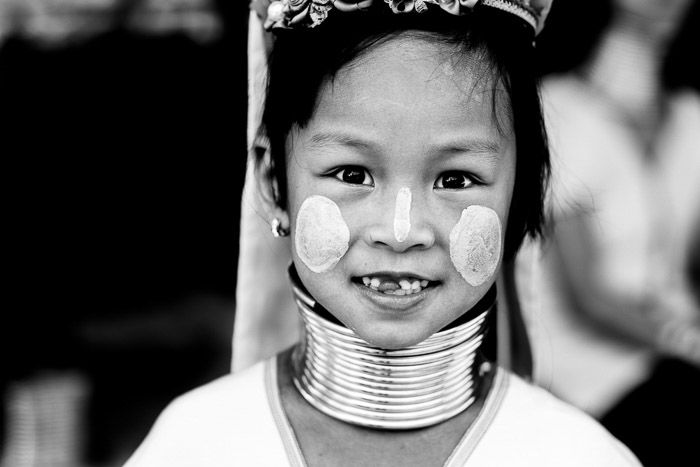 A close up portrait of a young Kayaw Girl in traditional dress and face paint - shallow vs deep depth of field