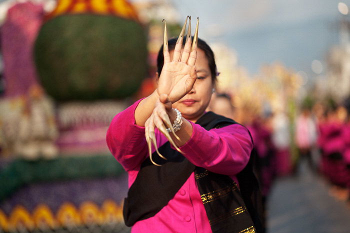 A photo of a Thai woman dancing in a street parade