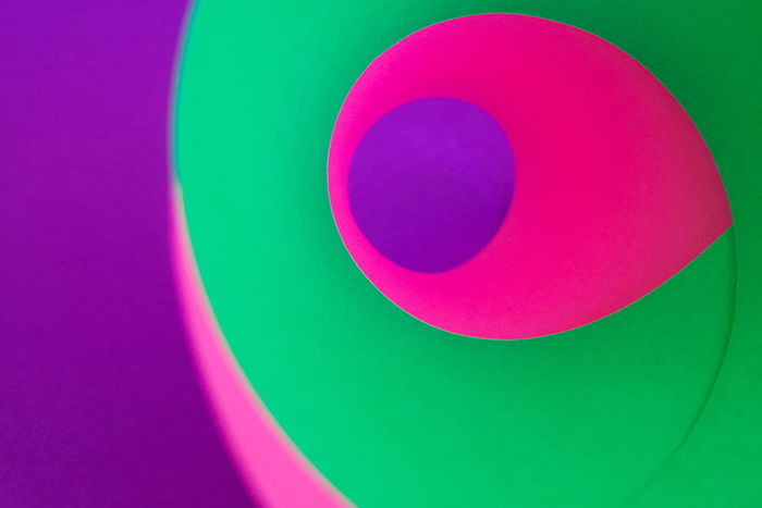 fun colorful abstract photo made using sheets of bright green, pink and purple colored paper