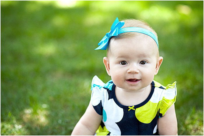 A newborn baby outdoors in dappled light