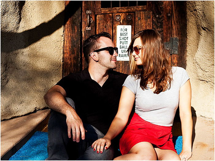 A couple posing outdoors in dappled light