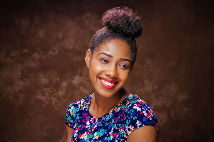 A portrait of a female model posing against a brown textured background - photoshop backgrounds