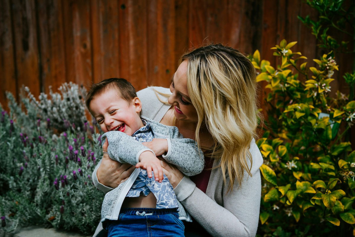 A child laughing in his mother's arms as an example for Easter picture ideas