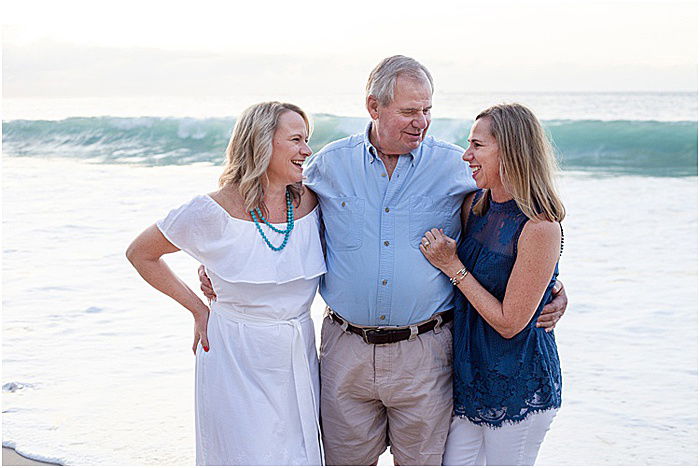 A sweet portrait of a family of three posing on the beach - emotional photography