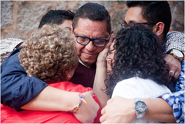 A candid portrait of a family in a group huddle - emotional photography