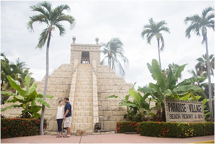 A couple posing outdoors in front of a stone structure - emotional photography