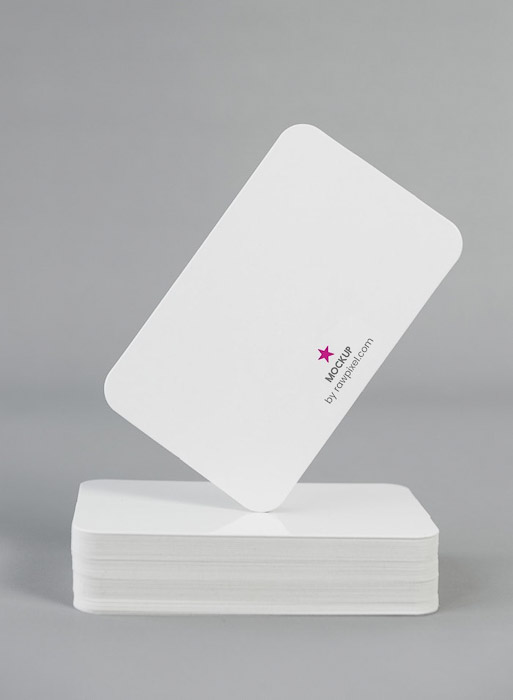 A stack of white photography business cards with a minimalist logo printed on them