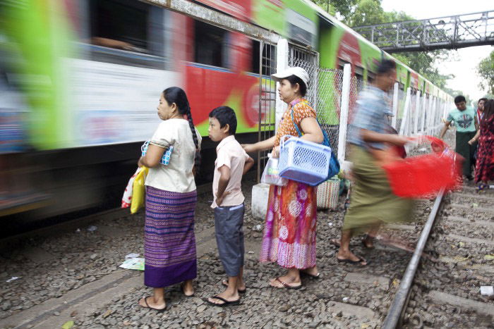 People waiting for the train which is passing with creative motion blur by using a slow shutter speed