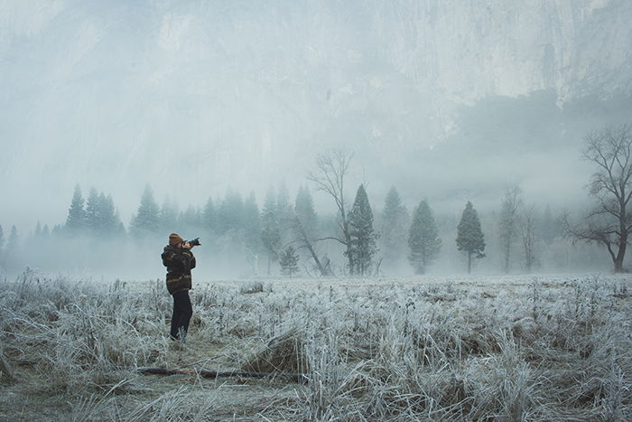 A photographer shooting in a magical winter landscape