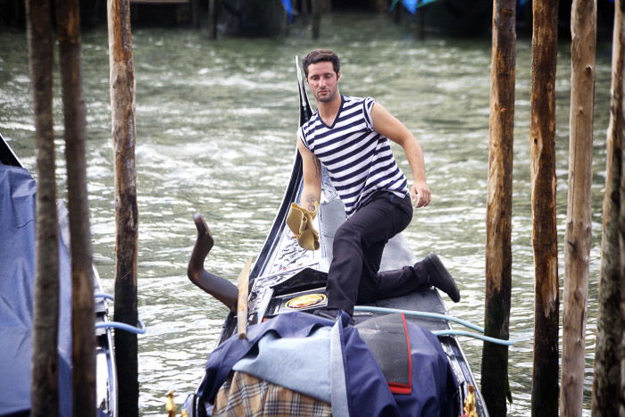 A gondolier along the grand canal in Venice. Venice photography tips