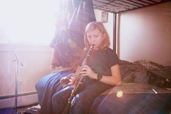 photo of a girl playing the clarinet with lens flare