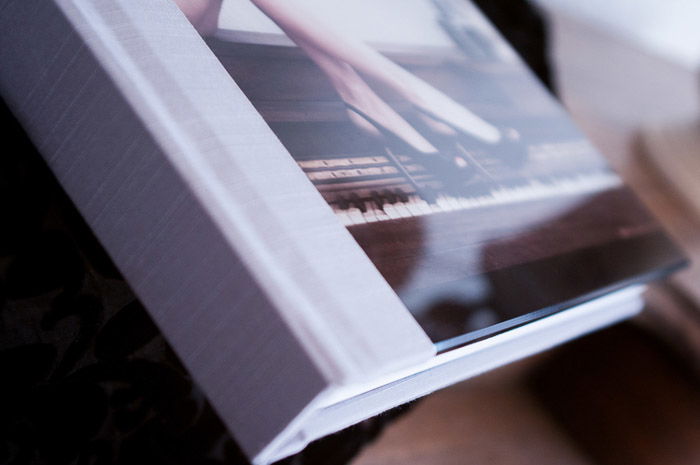 A cropped product shot of a photo book for how to become a boudoir photographer