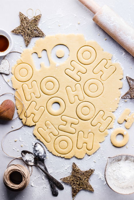 Festive food flat lay including cookie dough and Christmas decorations