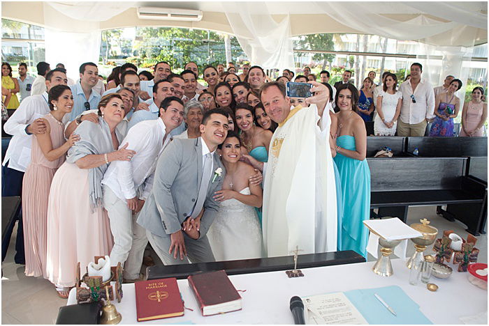 A group photo of a wedding party posing indoors - wedding flash photography