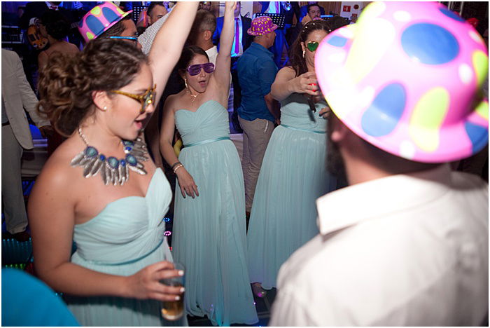 A candid wedding photo of guests dancing - wedding flash photography