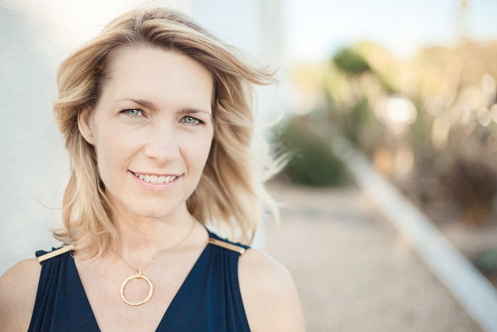 Bright and airy headshot photo of a female model outdoors