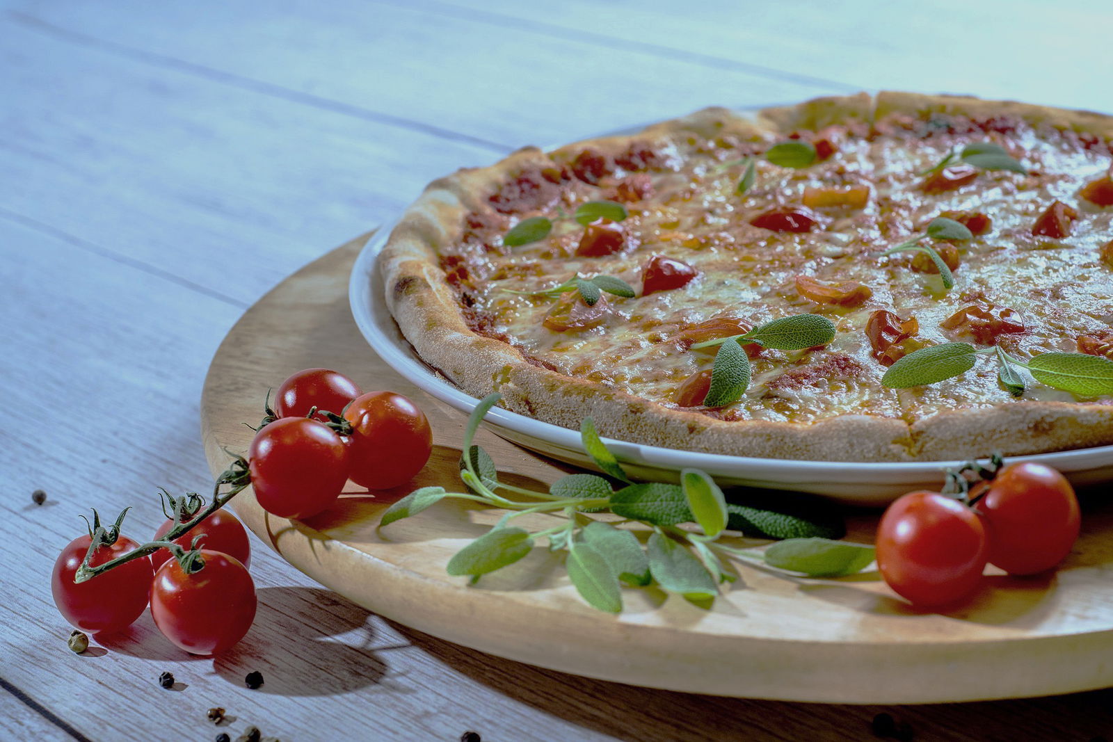 A food photography shot of a pizza with a blue tinge