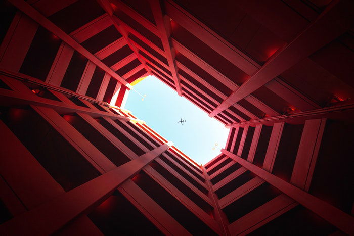 Airplane flying above a building 