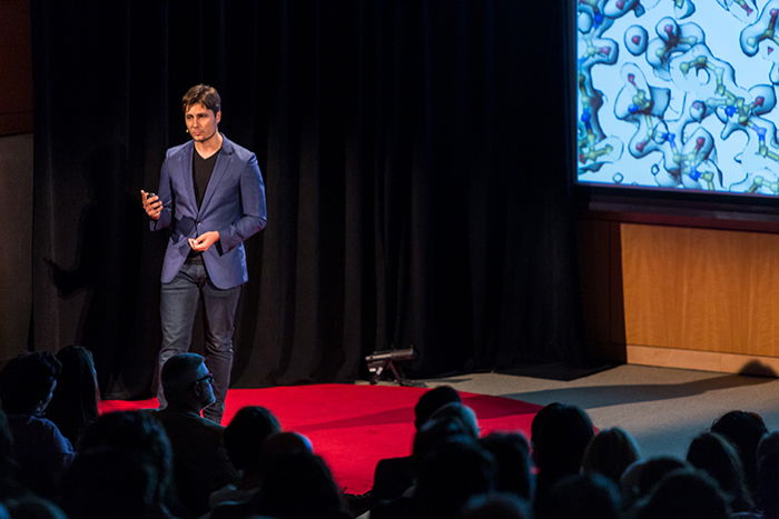 A public speaker onstage talking about how to make money with photography