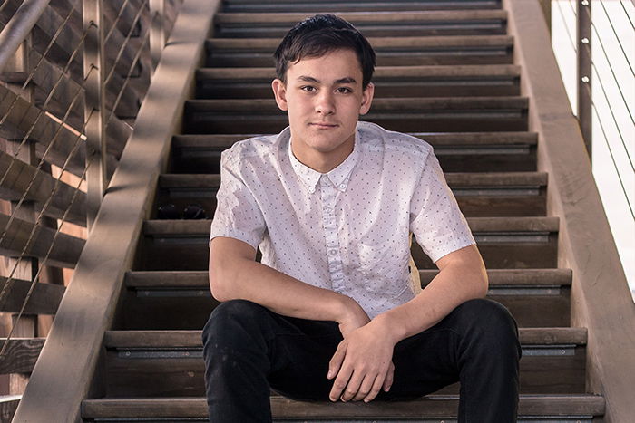 A portrait of a male model on steps of a building