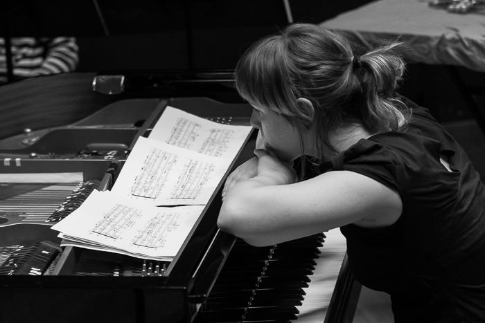 A black and white photo of a pianist onstage - stage photography tips