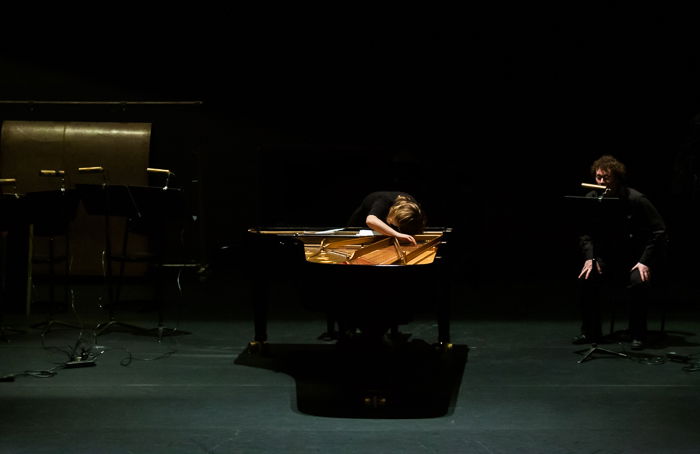 A stage photography shot of a musician playing piano onstage