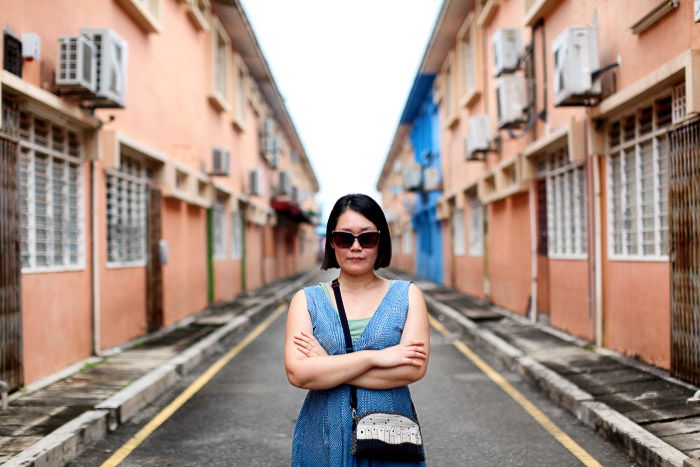 A femal model posing in the middle of the road 