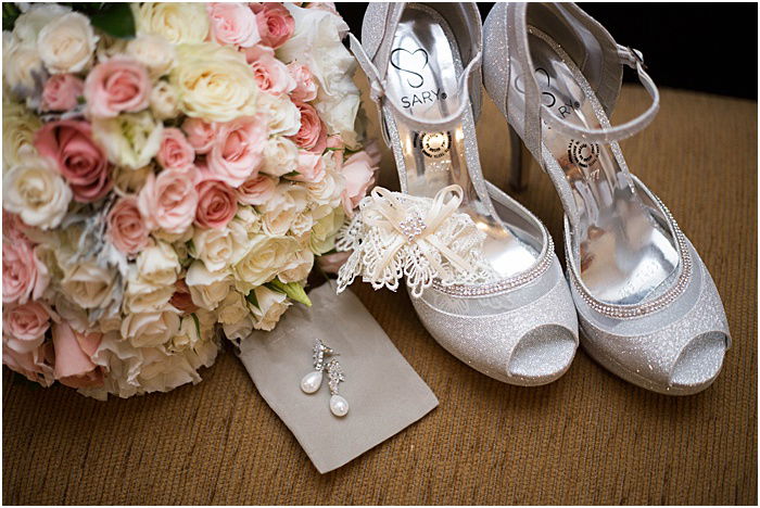 A wedding still life of flowers, earrings and shoes - wedding flash photography