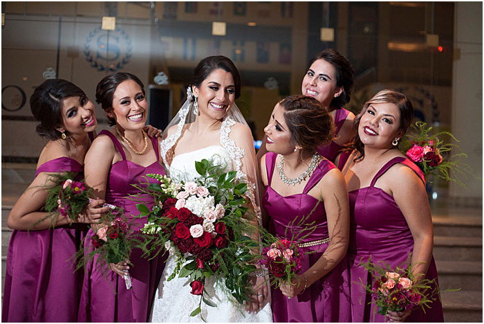 A group photo of a wedding party posing indoors - wedding flash photography