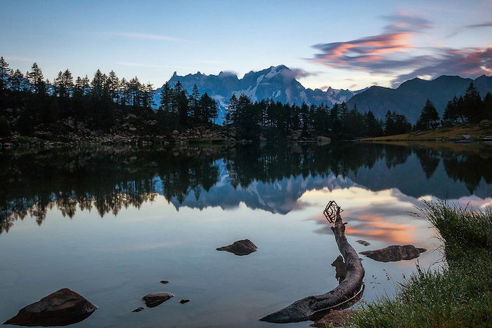 A stunning evening landscape by a lake, the huge depth of field of a wide angle lens to keep the background sharps