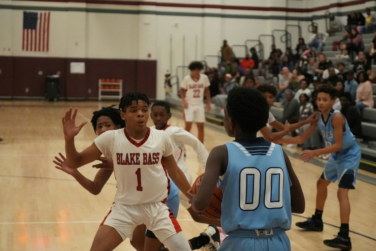 Players jostling for position for a ball about to be thrown in as an example for basketball photography