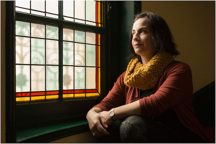 portrait of a female model posing by a window - short and broad lighting techniques