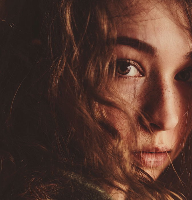 A cropped portrait of a moody female model - examples of dark portraits