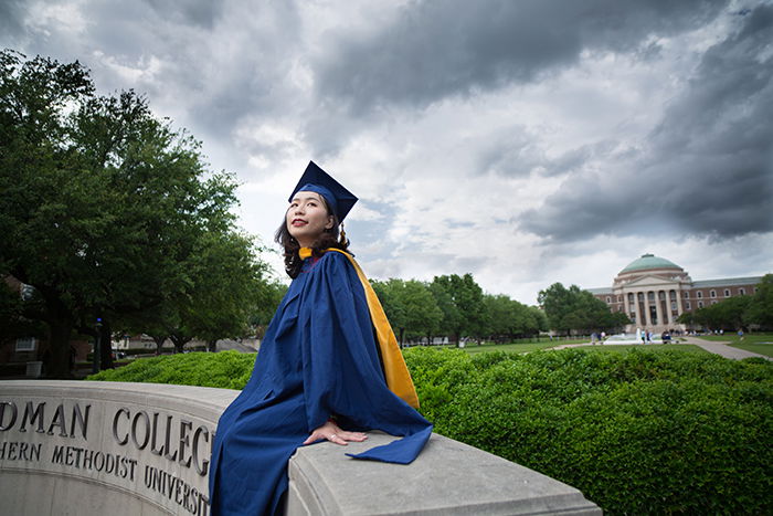 Beautiful graduation portrait of a female student posing outdoors