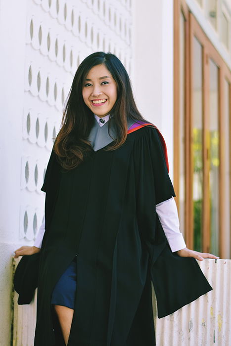 Beautiful graduation portrait of a female student posing outdoors