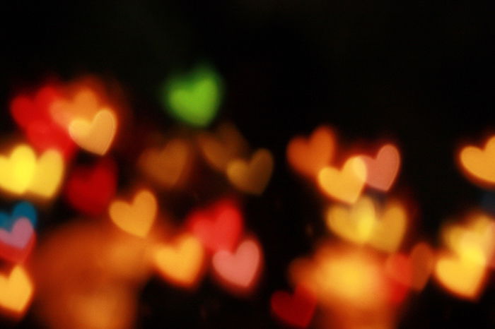 pretty heart shaped bokeh lights on dark background