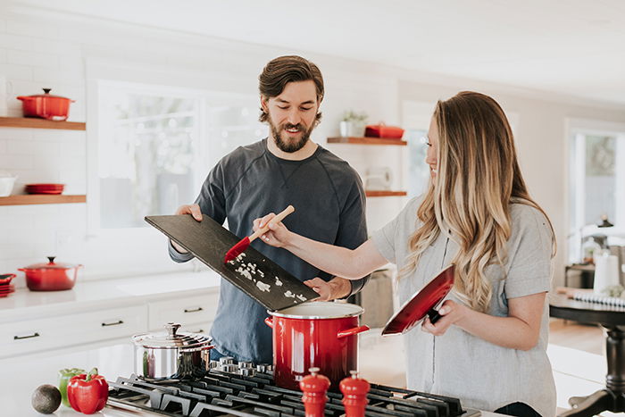 Casual lifestyle portrait of a couple cooking together