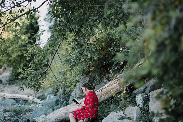 A female model reading a book under a tree - lifestyle portraits