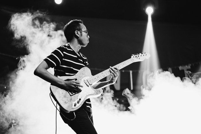 Atmospheric portrait of a performer onstage at a festival