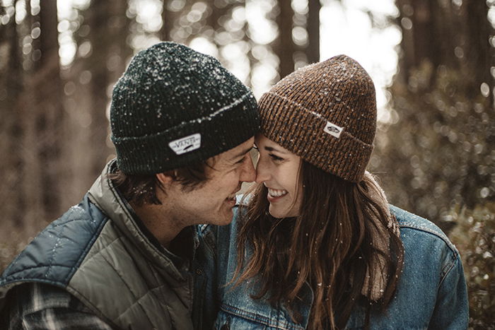 A smiling joyful couple in the snow - smile for the camera