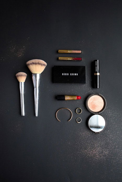 Flatlay product photography businesst shot of cosmetics on a dark background 